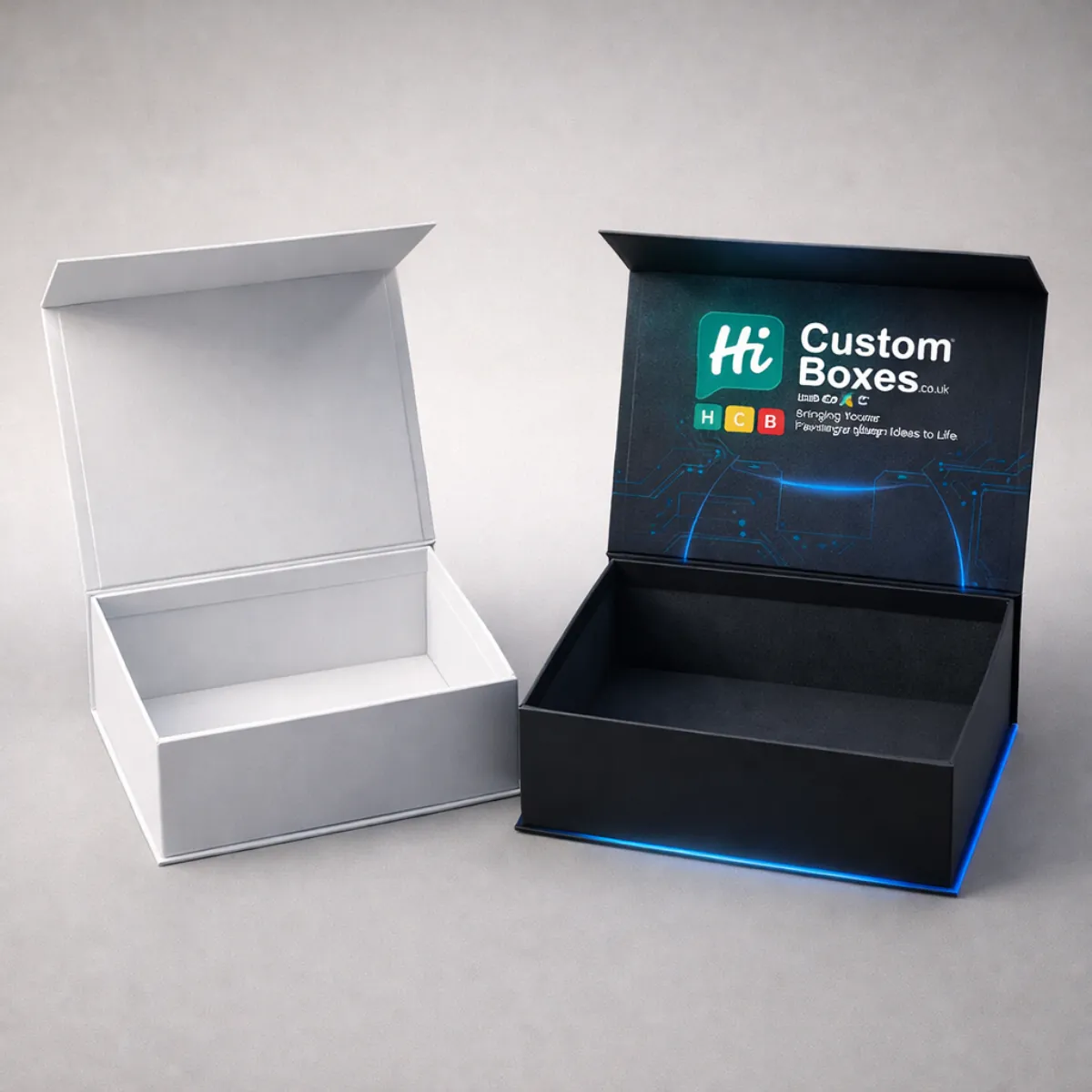 Two open magnetic-closure rigid boxes, one in plain white and one in branded black finish. class=